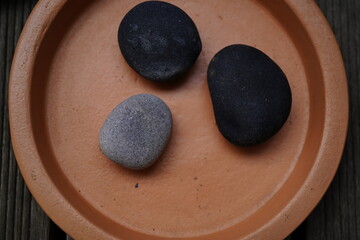 natural stones on a fuzz peach ceramic plant coaster