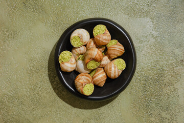 Overhead view of Edible snails stuffed with spicy herbal butter