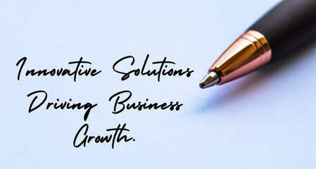 Fototapeta premium Innovative solutions driving business growth text with close up pen background. Business strategy and growth concept.