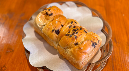 Fresh baked homemade sweet stuffed bread with chocolate and cheese for breakfast, Baked bun made of yeast dough in a rustic style on white background