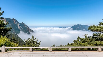 A tranquil mountain range rises above a thick blanket of fog in the valley, illuminated by the soft light of dawn, creating a captivating natural vista