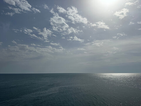 Ocean calm glittering waters and cloudy sky 