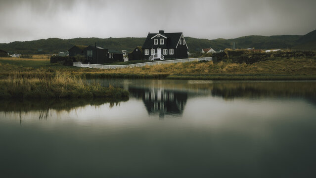 Beautiful nordic icelandic house reflected on a lake