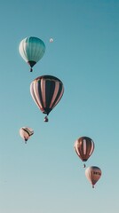 Naklejka premium several hot air balloons floating in the clear blue sky