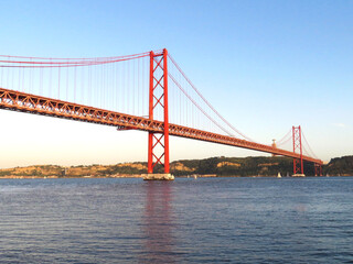 The view on the The 25 de Abril Bridge and the Tagus river from Lisbon, Portugal.