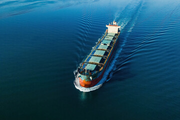 Bulk carrier or bulker underway in sea, ship for unpackaged bulk dry cargo, Aerial