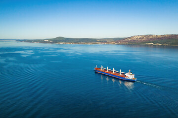 Bulk carrier full loaded dry cargo in underway in sea, aerial shot