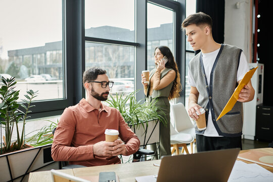 Colleagues engage in conversations in modern office.