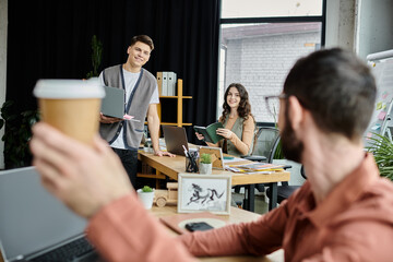 Team members engage in warm conversation in office.