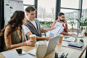 Team members engage in serious discussion in office.