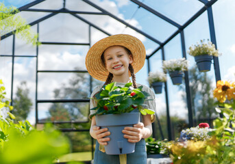 child is gardening in the greenhouse