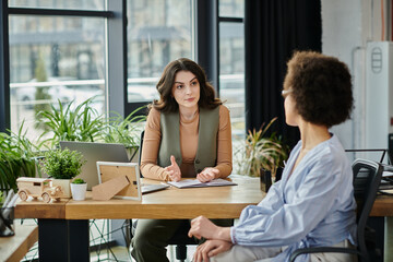 Colleagues engage in a serious discussion amidst a layoff process.