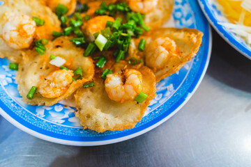 Vietnamese tiny shrimp pancake- Banh Khot Vung Tau. Vietnamese local cuisine. Served with vegetables. Selective focus