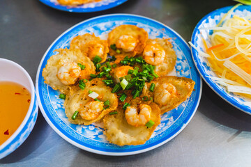Vietnamese tiny shrimp pancake- Banh Khot Vung Tau. Vietnamese local cuisine. Served with...