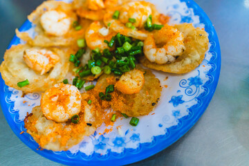 Vietnamese tiny shrimp pancake- Banh Khot Vung Tau. Vietnamese local cuisine. Served with vegetables. Selective focus