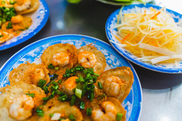 Vietnamese tiny shrimp pancake- Banh Khot Vung Tau. Vietnamese local cuisine. Served with vegetables. Selective focus