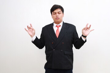 Calm man relaxing meditating, no stress free relief at work concept, mindful peaceful young businessman practicing breathing yoga exercises on isolated over white background