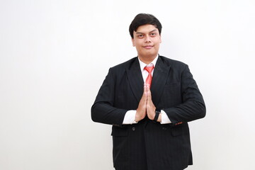 Smile asian businessman standing with welcoming hand gesture. Isolated on white