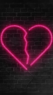 Broken heart neon light icon.Heartbreak glowing sign on brick wall background with smoke or fog effect.Cracked heart represents divorce,rupture, separation,lovesickness,etc.Wall decor banner animation