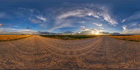 hdri 360 panorama on gravel road among fields in spring nasty evening before sunset in equirectangular full seamless spherical projection, for VR AR virtual reality content