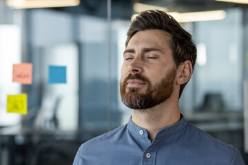 Office worker practicing mindfulness and relaxation in modern office setting