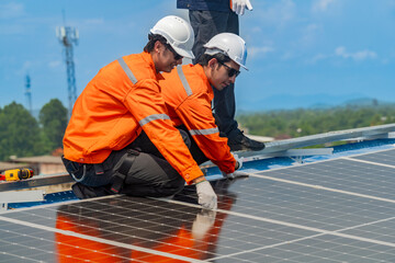 Worker Technicians are working to construct solar panels system on roof. Installing solar photovoltaic panel system. Men technicians walking on roof structure to check photovoltaic solar modules.