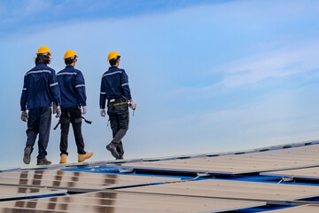 Worker Technicians are working to construct solar panels system on roof. Installing solar photovoltaic panel system. Men technicians walking on roof structure to check photovoltaic solar modules.