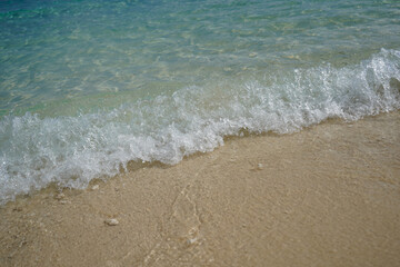 Waves on the edge of the sand on the beaches in the Bahamas. Natural background.