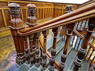 Vintage wooden stairs and railings in the old mansion interior close view background