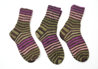 a pair of hand-knitted wool socks featuring a vibrant striped pattern