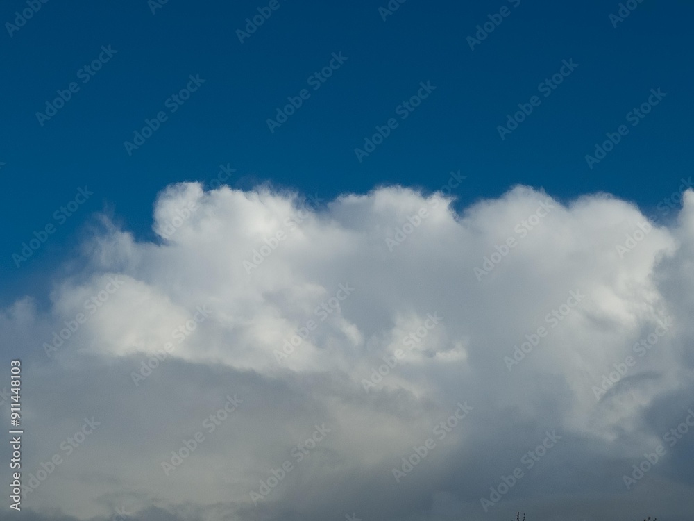 Poster Summer white fluffy cumulus clouds in the deep blue sky