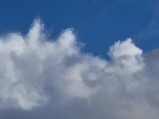Summer white fluffy cumulus clouds in the deep blue sky