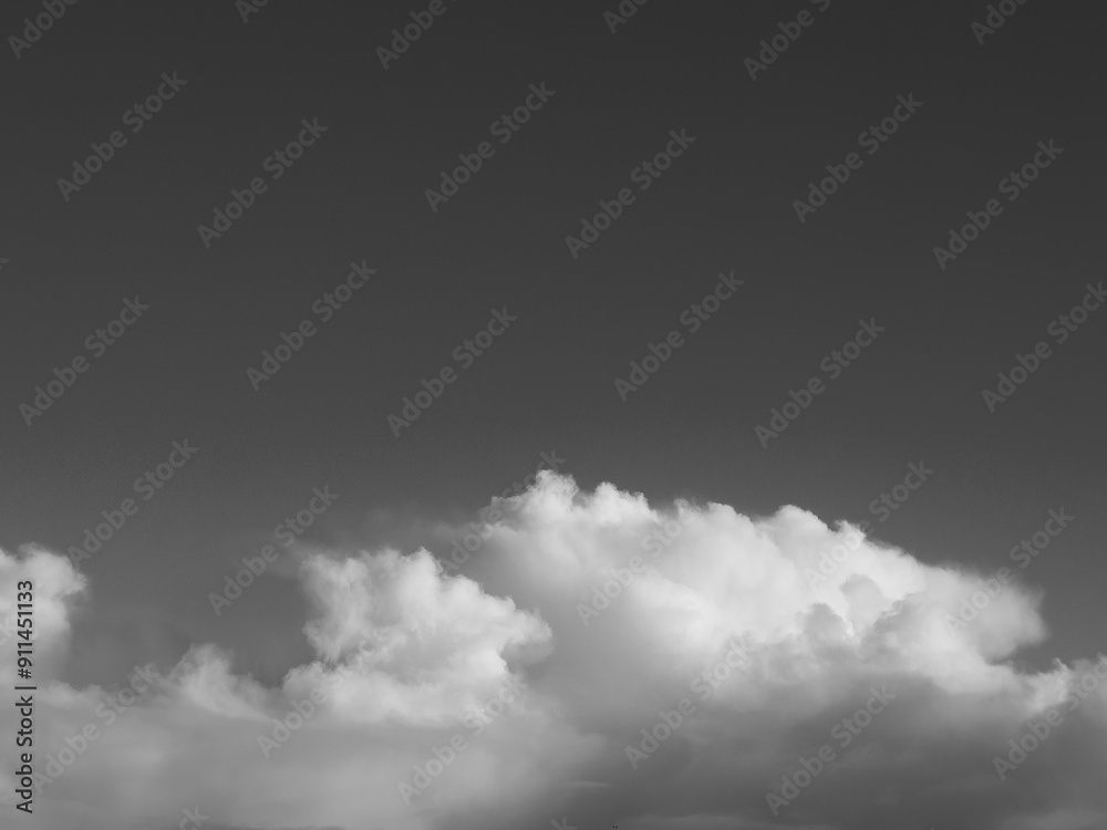 Poster summer white fluffy cumulus clouds in the deep blue sky. black and white monochrome grayscale photo