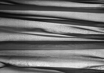 Fototapeta premium Deep blue glossy cloth texture background. Natural textile material photo, pattern cover. Black and white monochrome grayscale photo