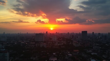 Fototapeta premium Sunset over Lumpini area from a rooftop bar in Bangkok, showcasing the vibrant cityscape and sky colors.