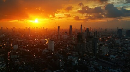 Fototapeta premium Sunset over the Bangkok cityscape from a rooftop bar in Lumpini area, with a golden sky and vibrant lights.