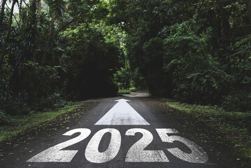 New year 2025 or straight forward concept. Text 2025 written on the road in the forest. Concept of planning, goal, challenge, new year resolution..
