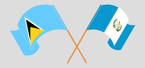 Crossed and waving flags of Saint Lucia and Republic of Guatemala