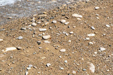Close up view of a beautiful beach filled with colorful sea stones, perfect for use as a wallpaper or detailed background image.