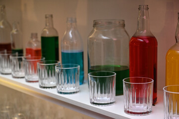 bar decoration, bottles on racks, bottles with colored liquid, colored liquid, colored bottles
