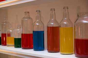 bar decoration, bottles on racks, bottles with colored liquid, colored liquid, colored bottles
