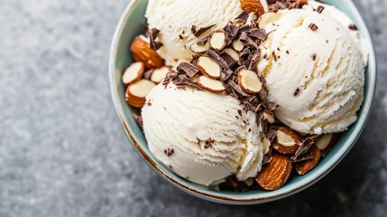 Dairy-free coconut ice cream served in a bowl with chocolate shavings and sliced almonds