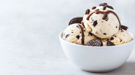 Dairy-free cookies and cream ice cream topped with crushed Oreos and a drizzle of chocolate sauce
