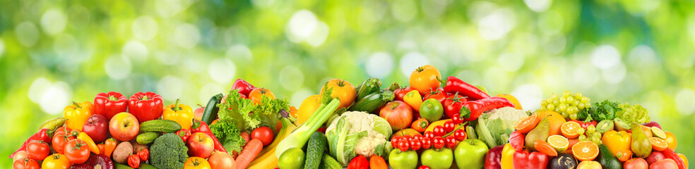 Collection of fruits, berries and vegetables on green