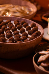  brigadeiro, chocolate on a plate, chocolate ball, chocolate,brigadeiro, candy table, glass bowl, brazilian sweets, brigadeiro on a plate, candy store, showcase
