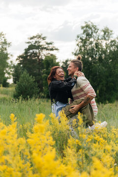 Young Couple fooling around and Laughing in a Meadow

