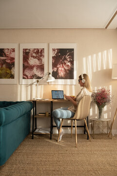 Young woman using smartphone at home office. 