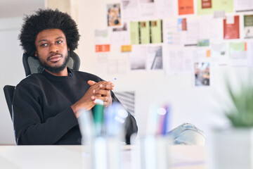 Relaxed sitting at office desk