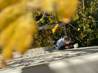 Grandmother fixing the surveillance camera on the wall 