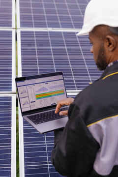 Solar power electricity company manager data entering laptop